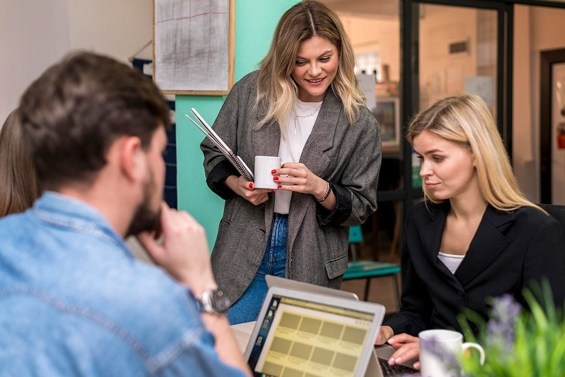 Corporate meeting: Put your feet up as the team plans. Relaxed office atmosphere.