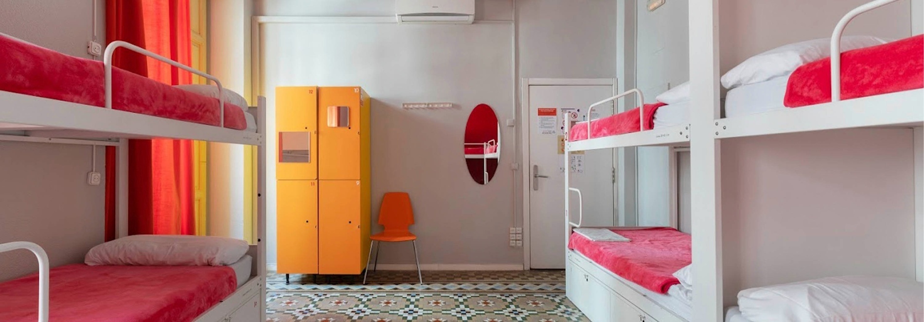 Bunk beds with red bedding at Red Nest Hostel Valencia | Feet Up | Valencia.
