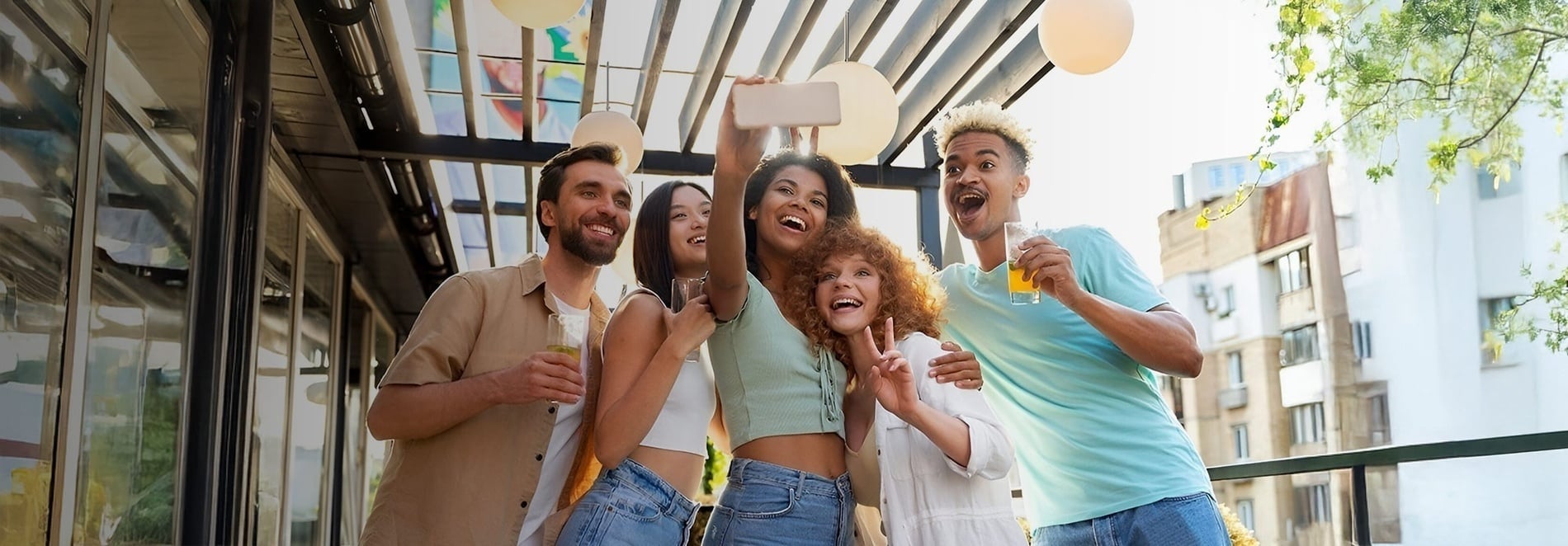Friends toasting on a hotel terrace. Feet up: an ideal corporate vibe!