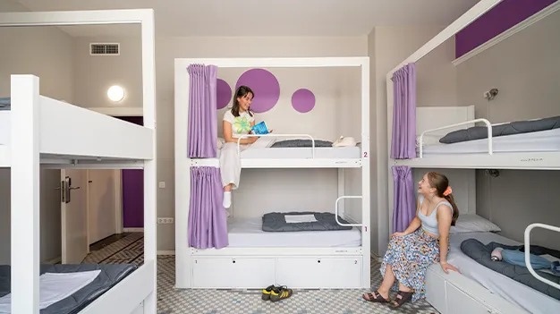 Modern hostel with bunk beds to sleep and relax. Feet up, corporate!