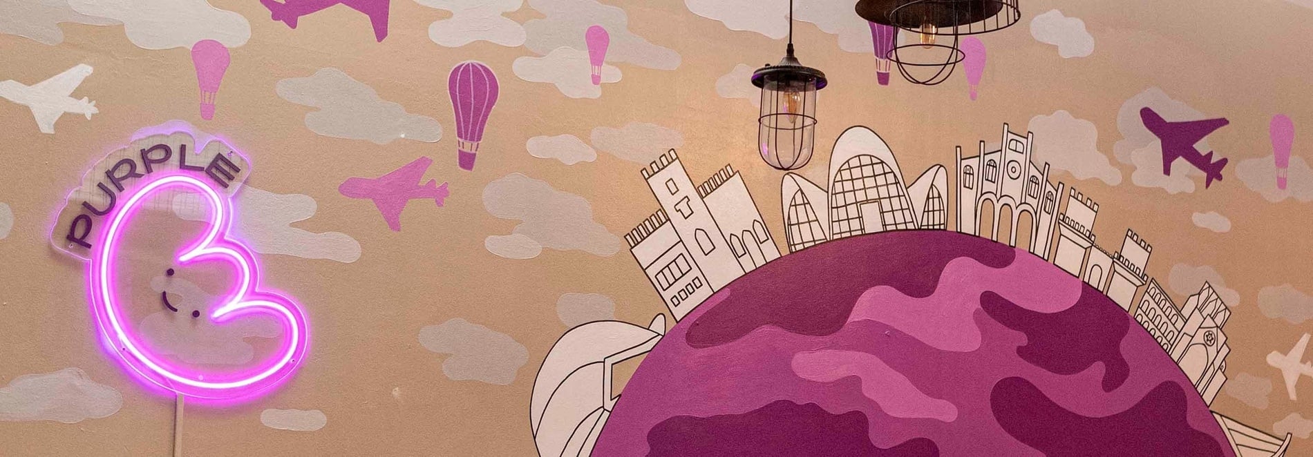 Purple Nest Hostel Valencia | Fun neon art, planet & planes theme for a playful stay.