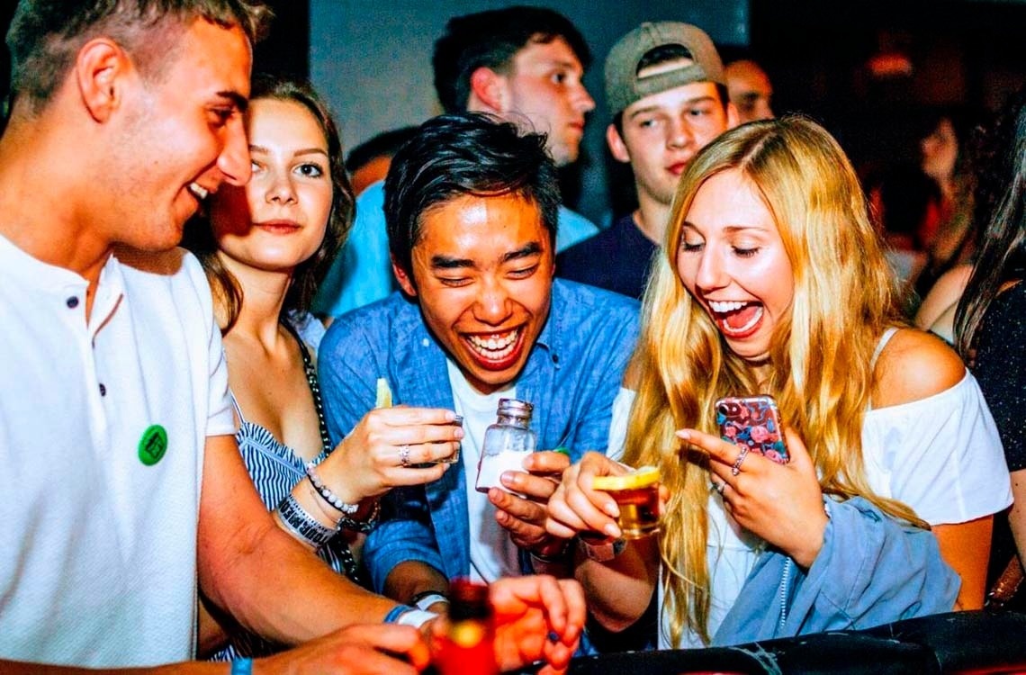 Laughing with friends and toasting. Have a great time with your people! Feet up: Corporate.