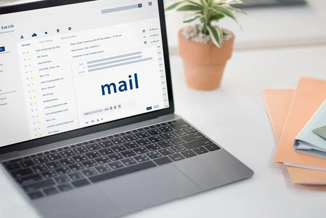 The Fives Corpo: Laptop with open email screen on a desk.