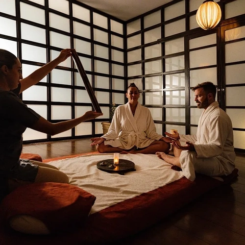 The Fives Corpo spa: Sound healing with singing bowl in a tranquil room.