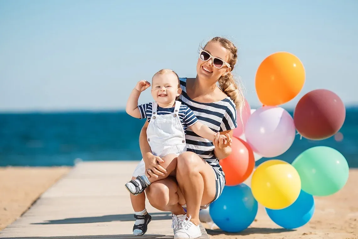 Mother and child with balloons at The Fives, perfect for family holidays.