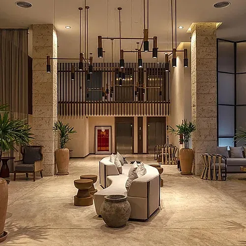 The Fives Corpo lobby: modern design with plants and curved sofas.