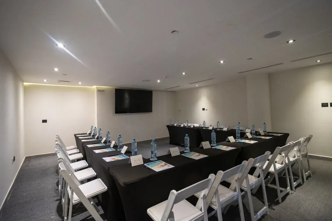 The Fives Corporate conference room with U-shaped tables and chairs.