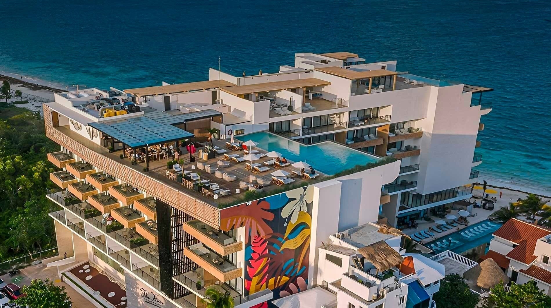 a large white building with a swimming pool on top of it