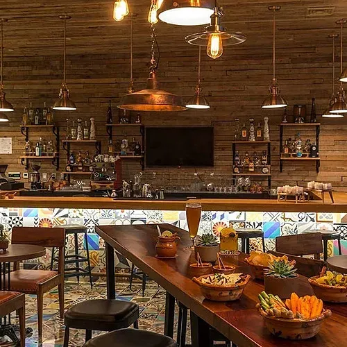 The Fives Corpo bar: chic ambiance with modern decor, art, and spirits.