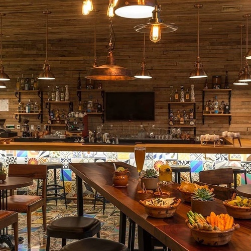 a bar with a painting of a woman on the wall