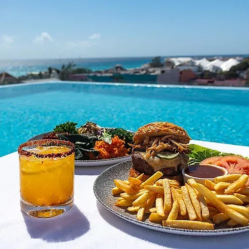 Enjoy a burger & cocktail poolside at The Fives Corpo.
