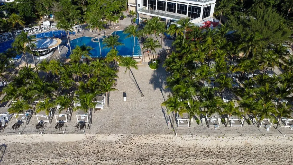 Aerial view of The Fives Corpo resort with pool and private beach.