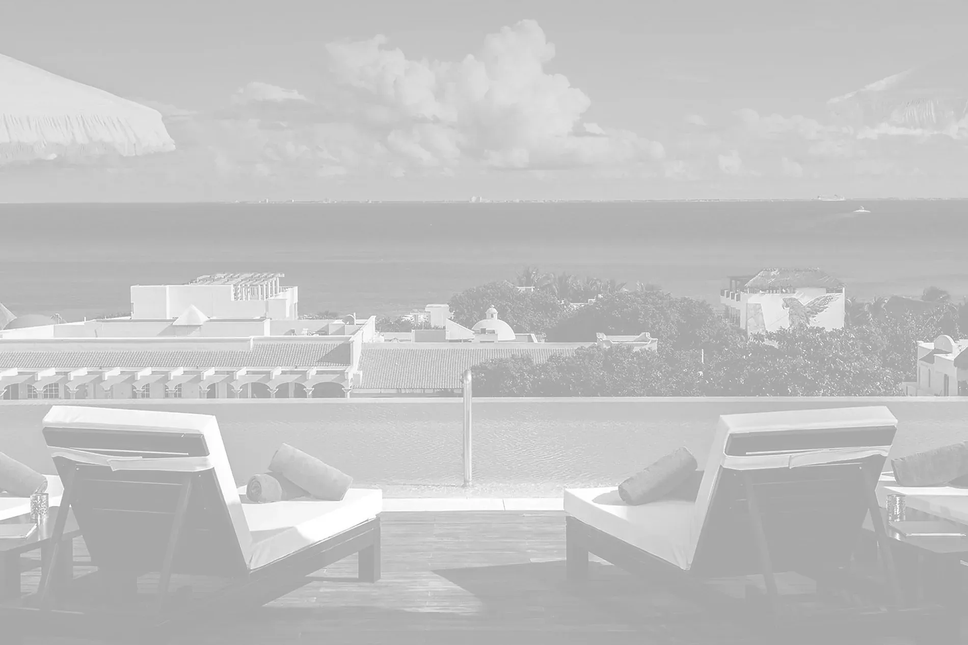 The Fives Corpo: Lounge chairs and infinity pool overlooking the ocean.=s1900