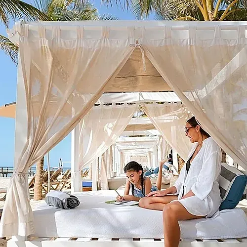 Enjoy family time at The Fives Corpo. Beach cabanas, sea, and sun.