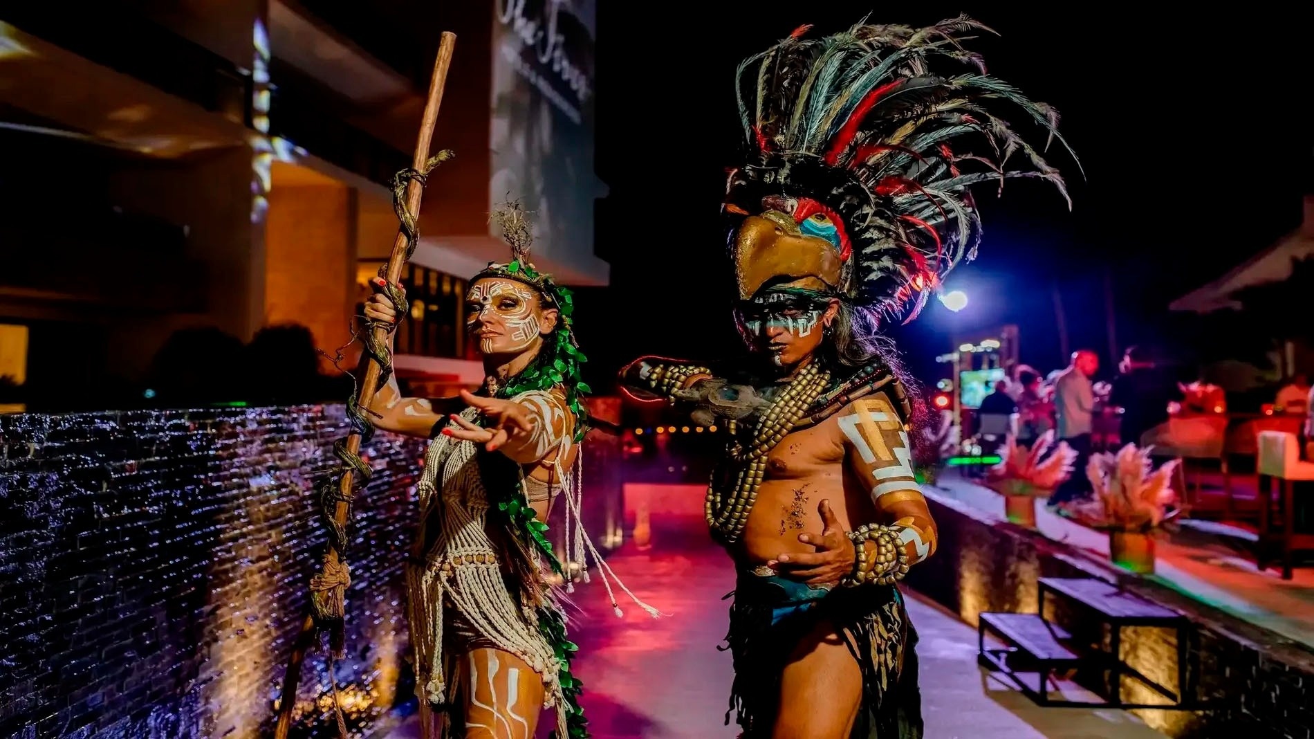 a man and a woman are dressed in native american costumes