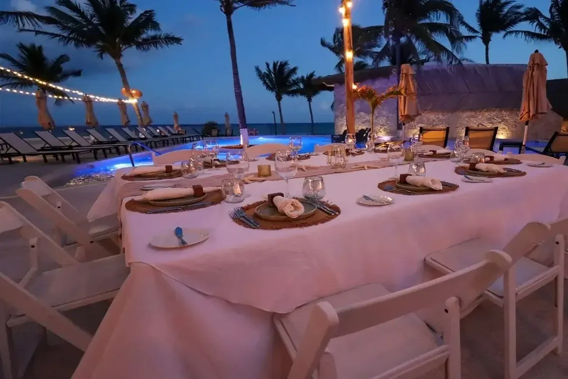Outdoor dining table at The Fives Corpo, poolside ambiance.