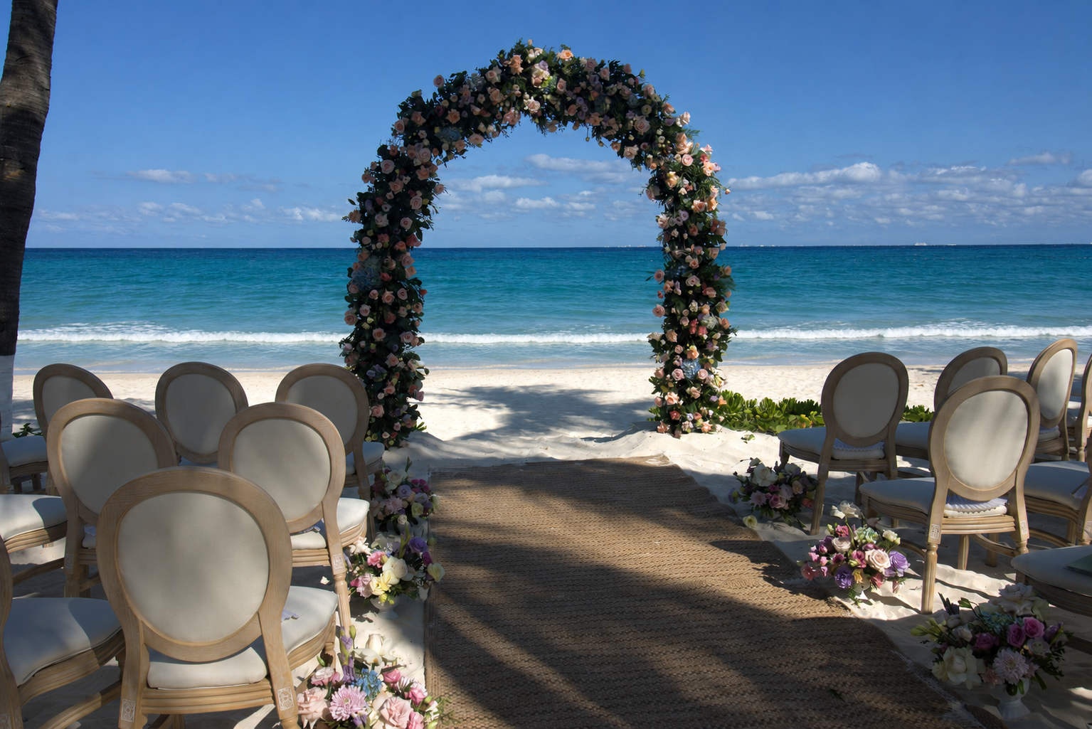 Beach wedding aisle with tropical flowers and ocean views