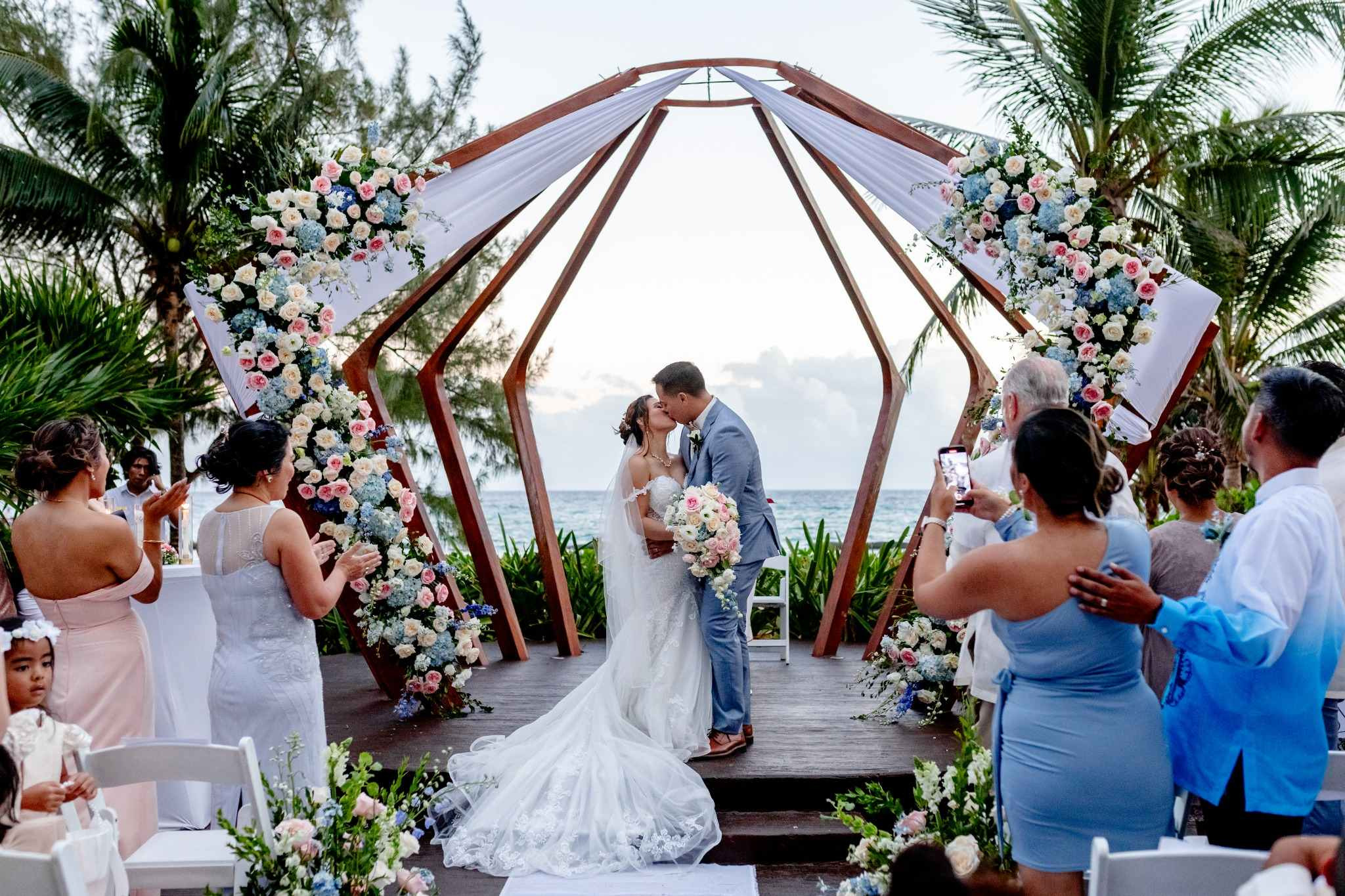 Newlyweds embracing by an infinity pool at a The Fives Corpo wedding venue.