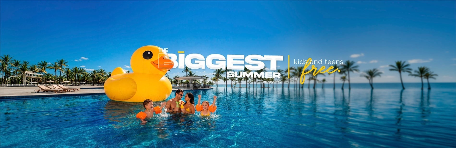 a man and woman standing on a balcony overlooking a swimming pool