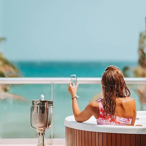Relax at The Fives Corpo with ocean views and champagne.