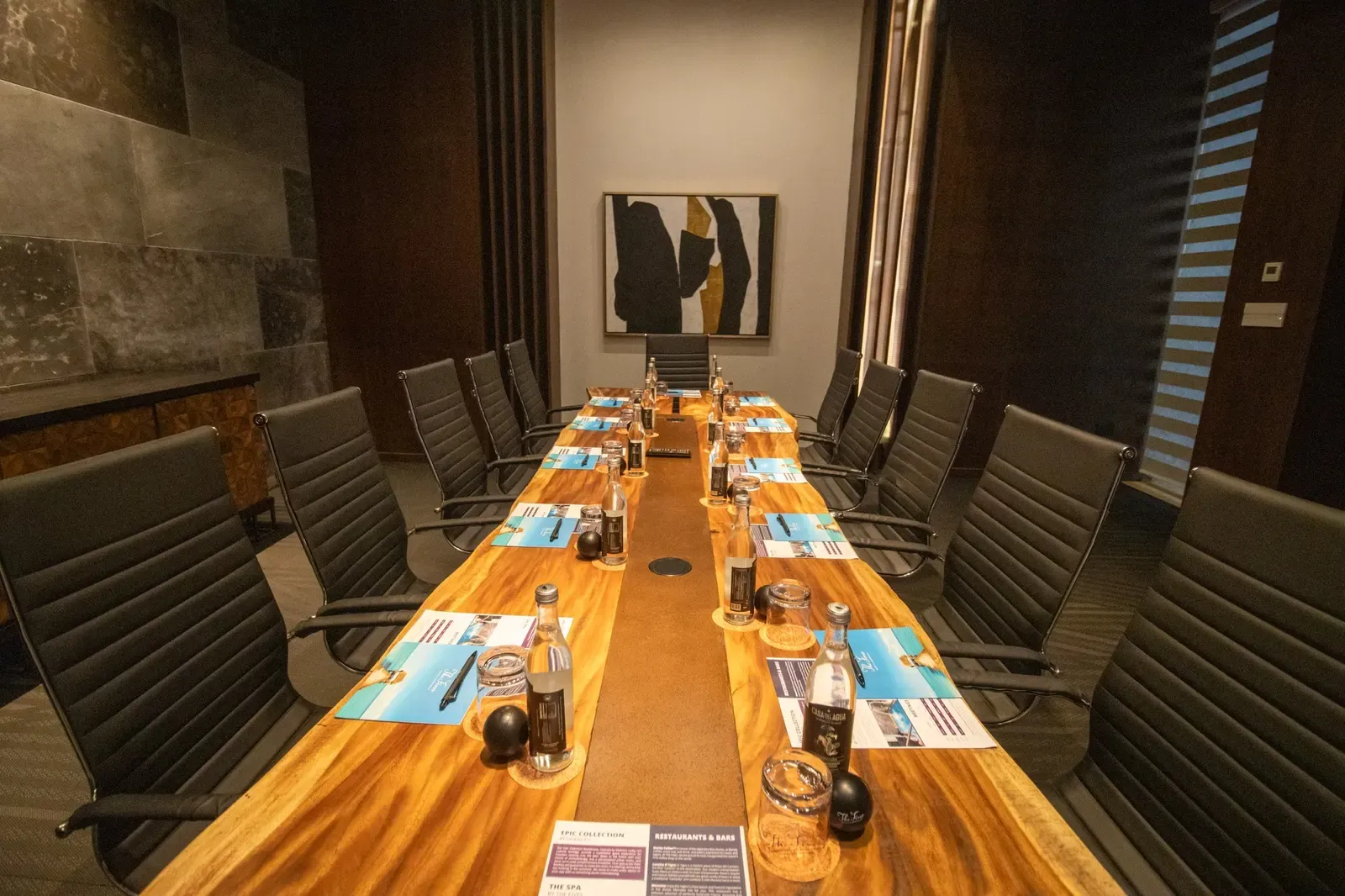 Luxury The Fives Corpo conference room with a live-edge table and modern chairs.