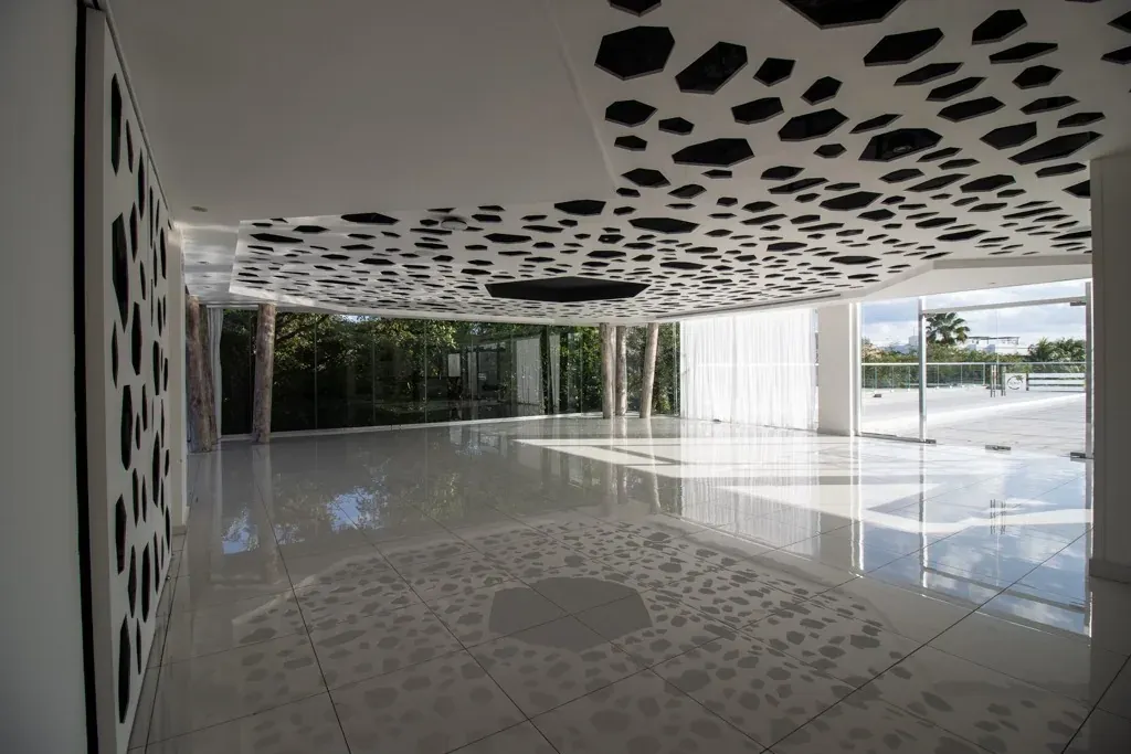 The Fives Corpo lobby's striking ceiling with cutouts and floor reflections.