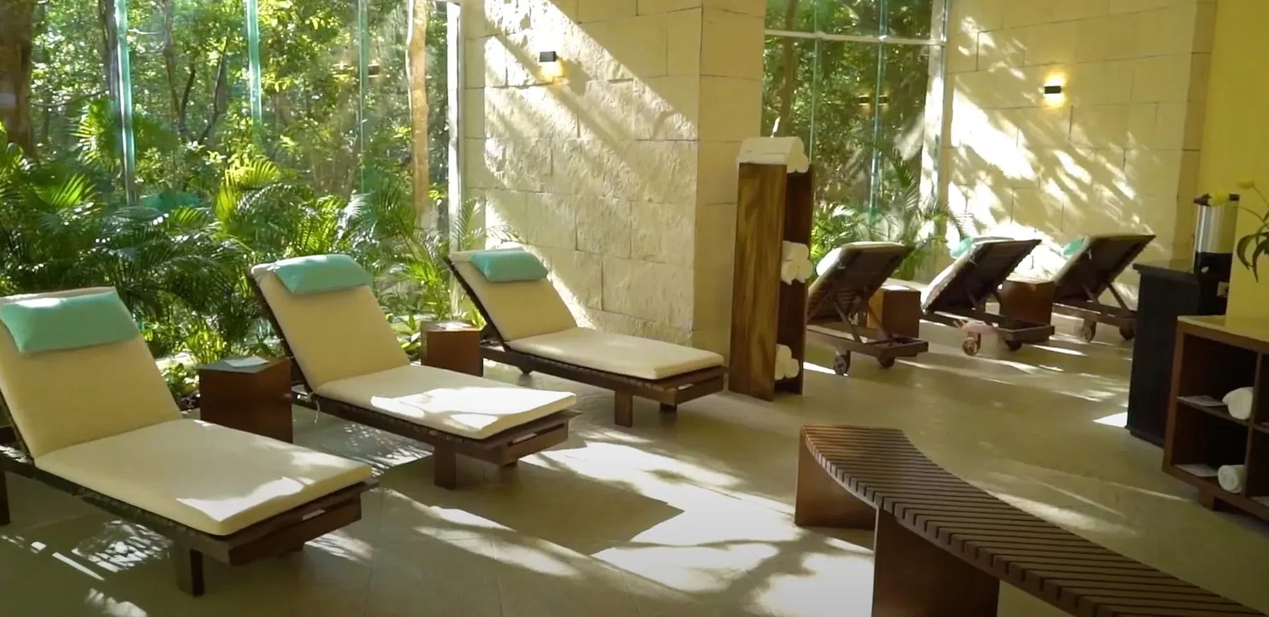 Relax at The Fives Corpo: Lounge chairs and lush greenery by the window.