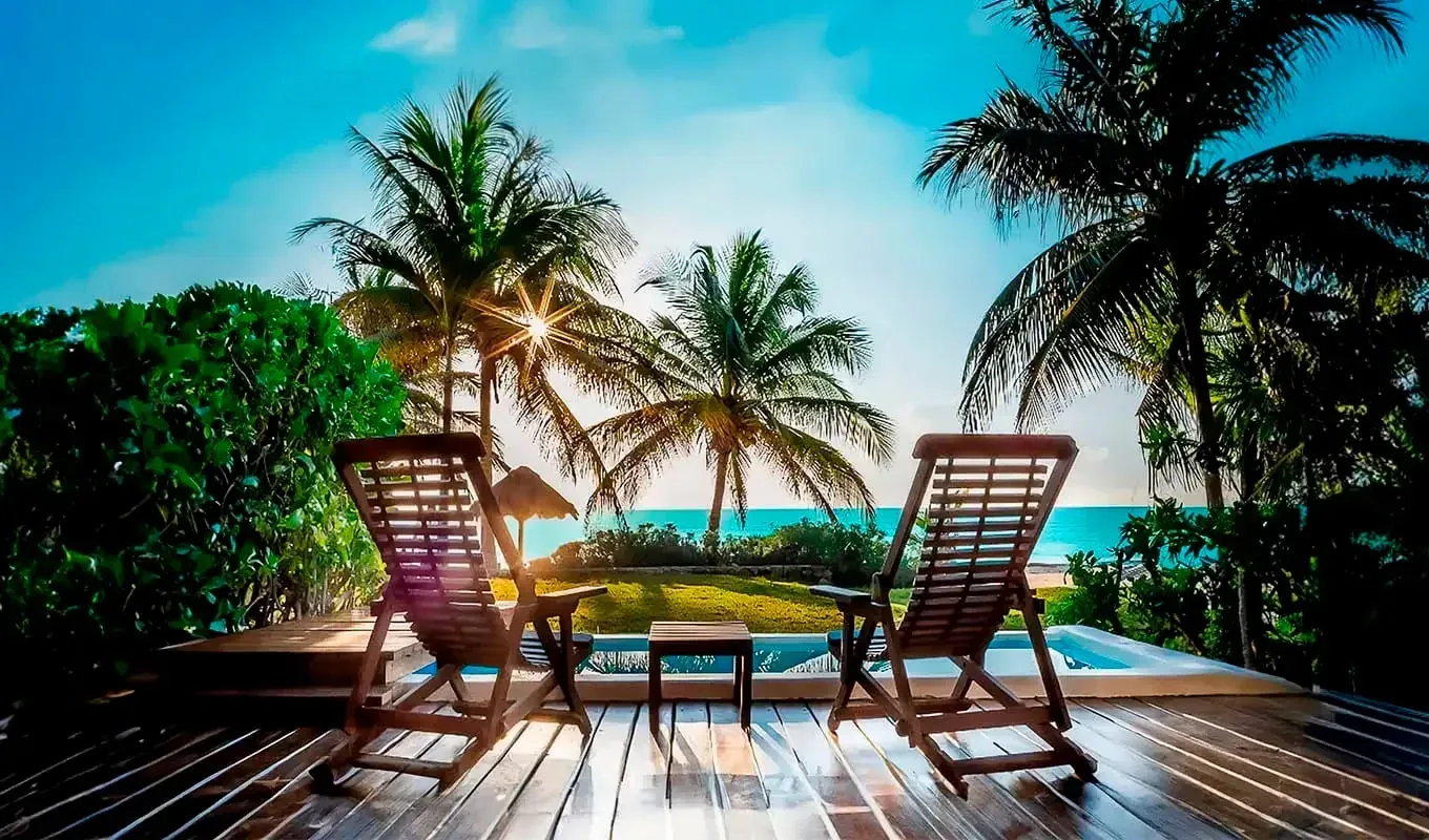 The Beachfront: Refugio Riviera Maya con sillas de playa y vista al mar.