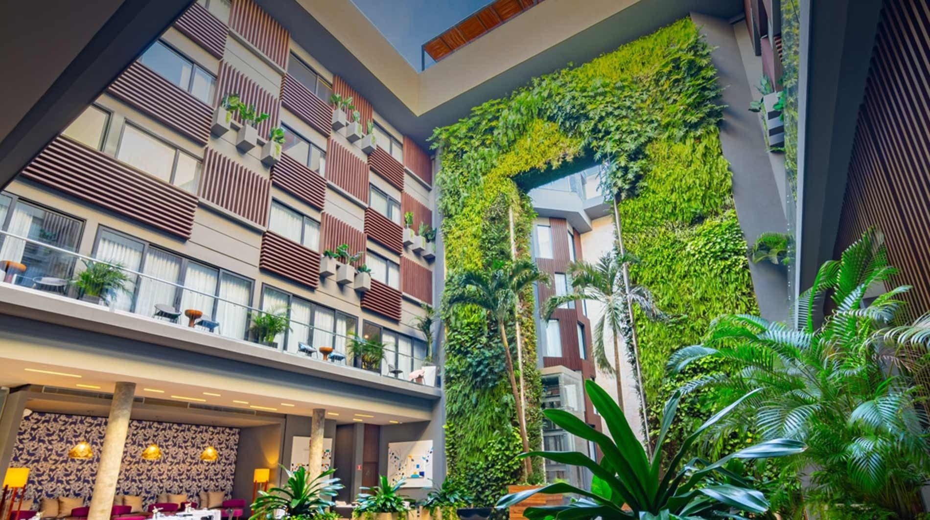 a building with lots of windows and plants on it