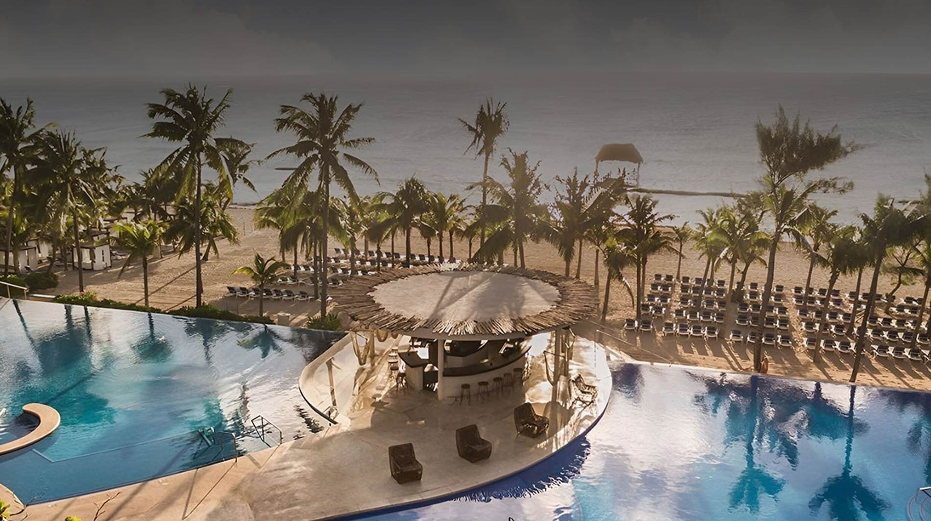 a large swimming pool with a bar in the middle