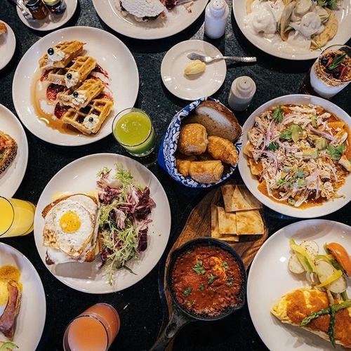 a table topped with plates of food and drinks