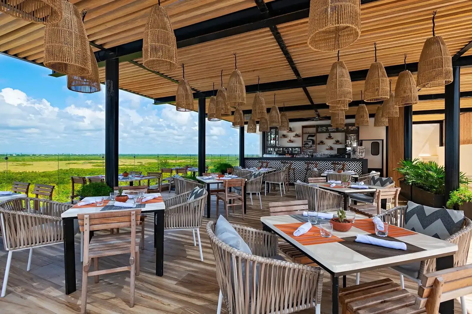 RestauranteThe Fives Corpo al aire libre con mesas puestas, vista al paisaje y barra de bar.
