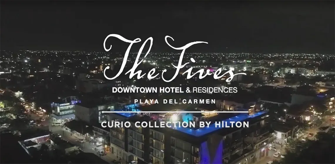 The Fives Downtown Hotel & Residences at night in Playa del Carmen.
