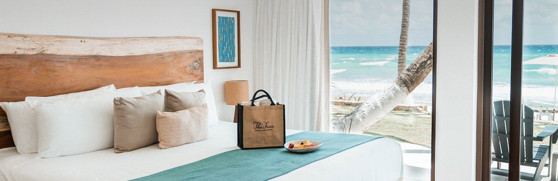 a hotel room with a bed and a bag that says " the grove " on it