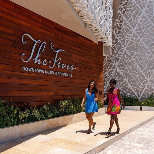 two women walk in front of the fives downtown hotel and residences