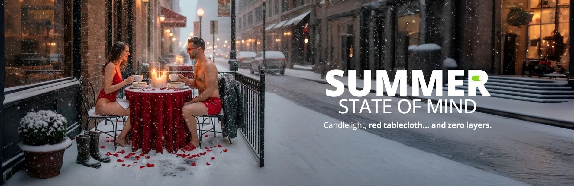 A couple in red swimwear dines at a candlelit table covered in a red cloth, surrounded by falling snow on a city street, accompanied by text promoting a "SUMMER STATE OF MIND."