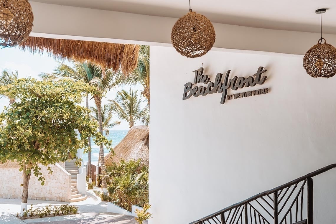 The Beachfront by The Fives hotel: ocean views, palm trees, and a luxurious tropical setting.