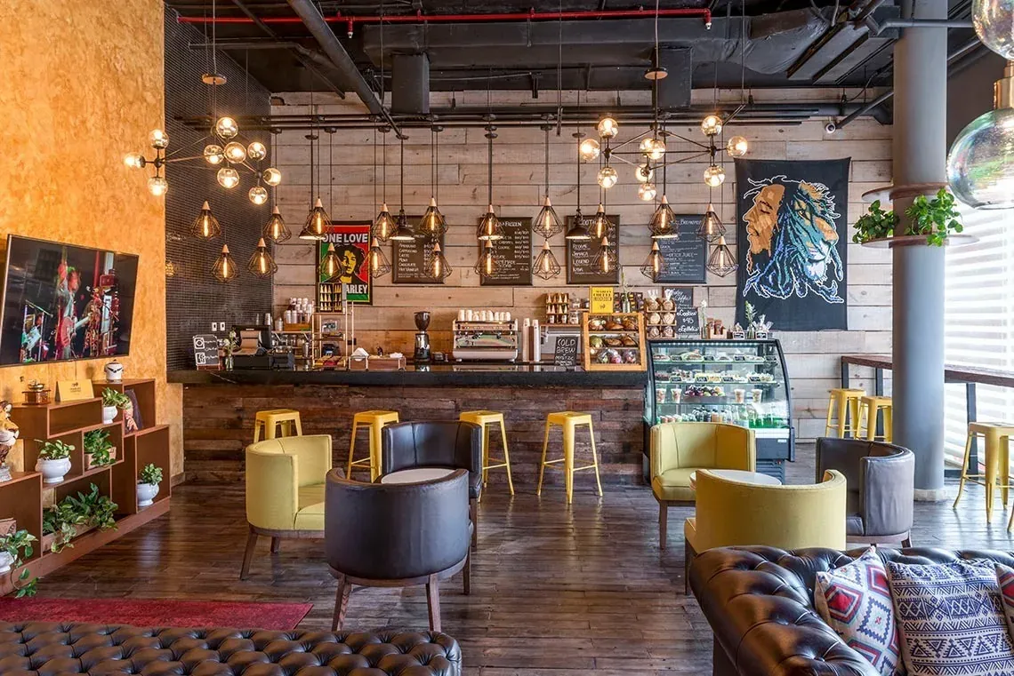 The Fives Corpo's inviting coffee shop with a wooden bar and comfortable seating.