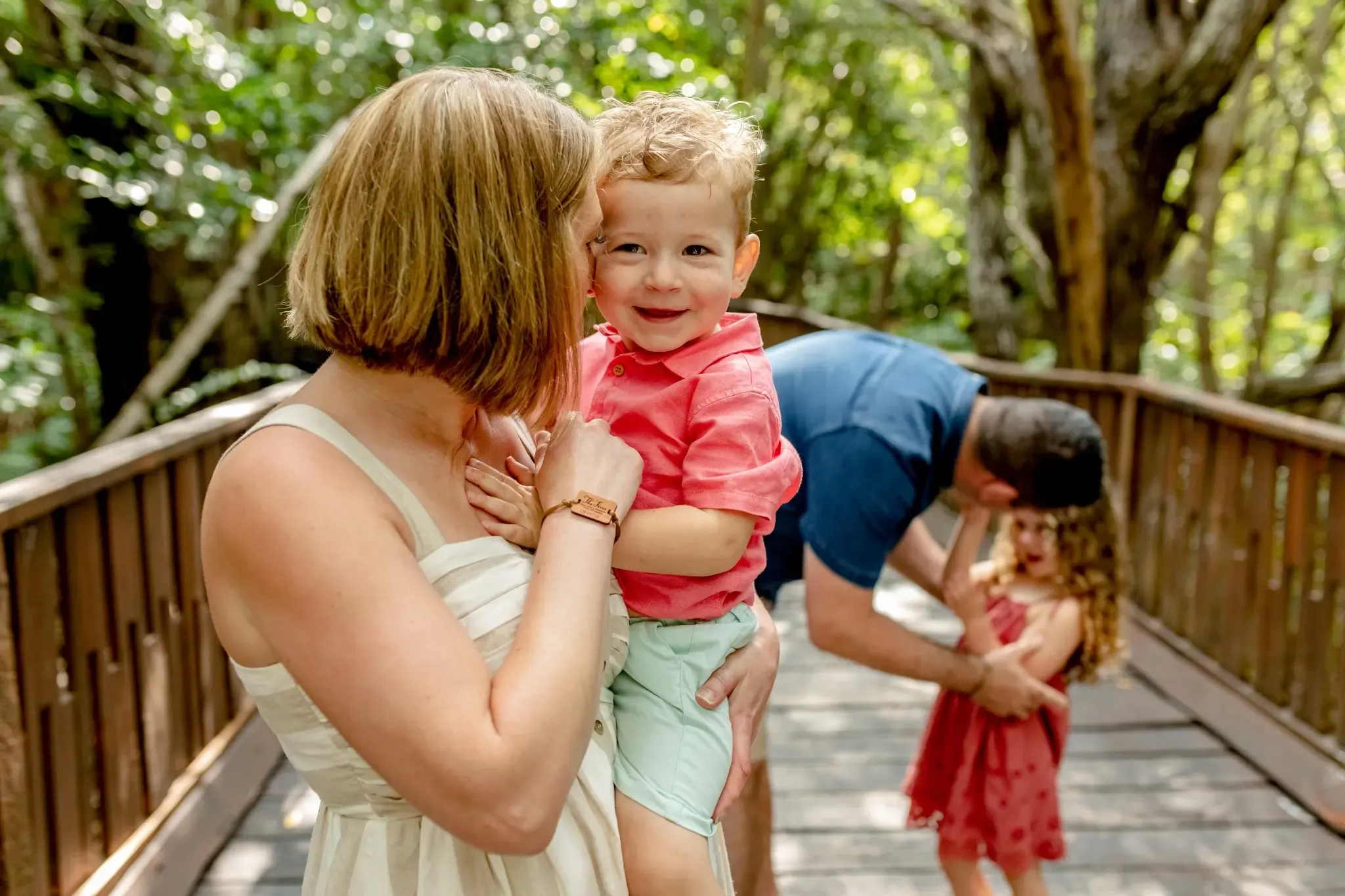 Family enjoying a wooded walkway vacation The Fives Corpo.