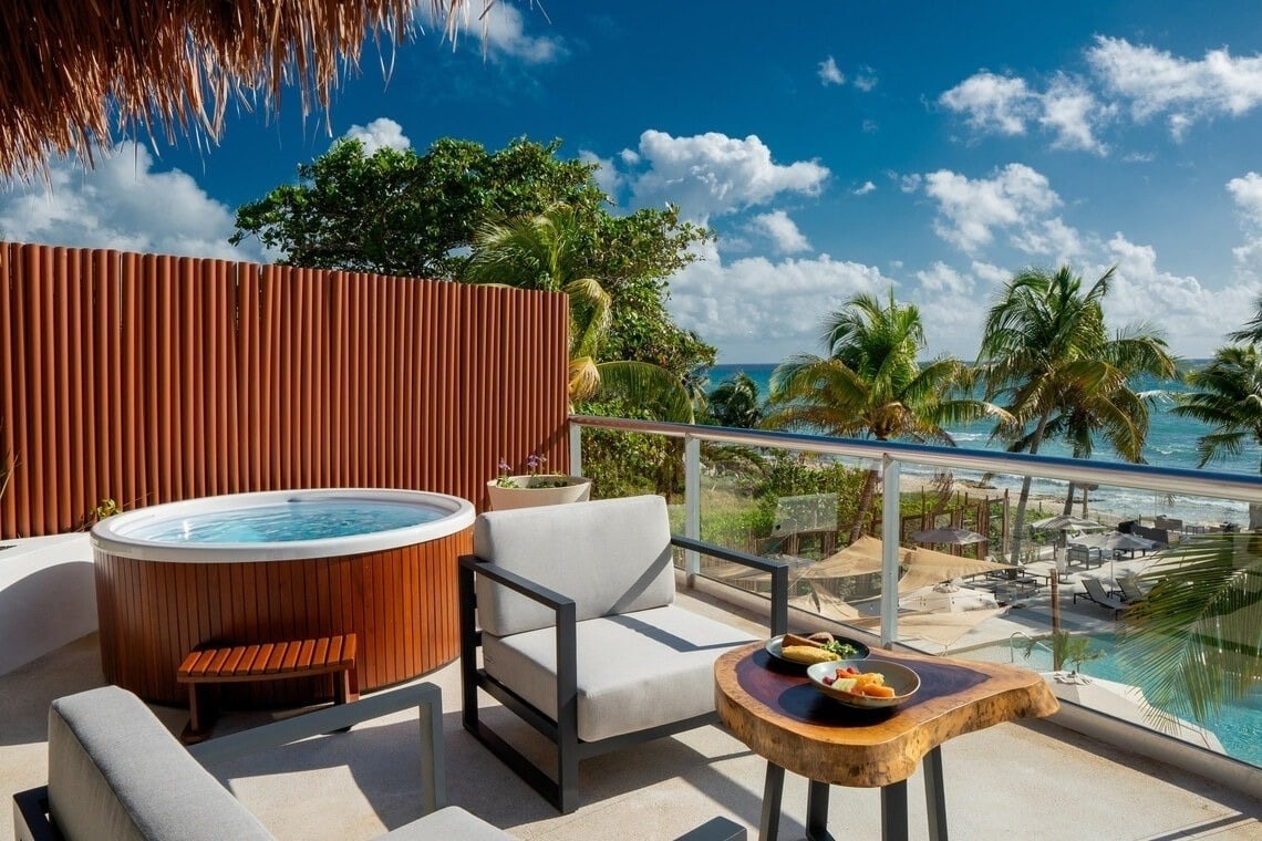 Balcony jacuzzi & lounge with ocean views at The Fives Puerto Morelos.