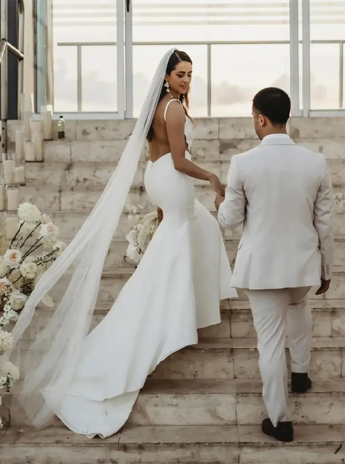 Newlyweds ascend stairs at The Fives Corpo