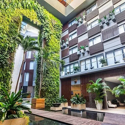 The Fives Corpo hotel with vertical gardens and reflecting pool.