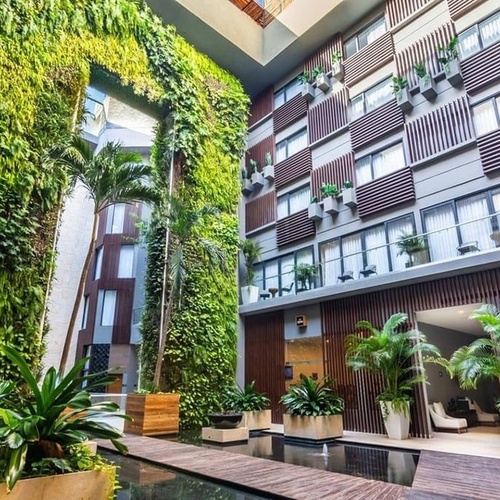 a large building with lots of windows and plants