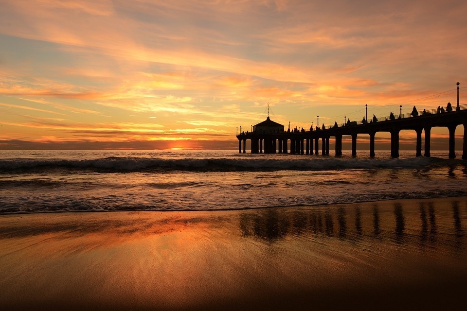 a pier with a sunset in the background