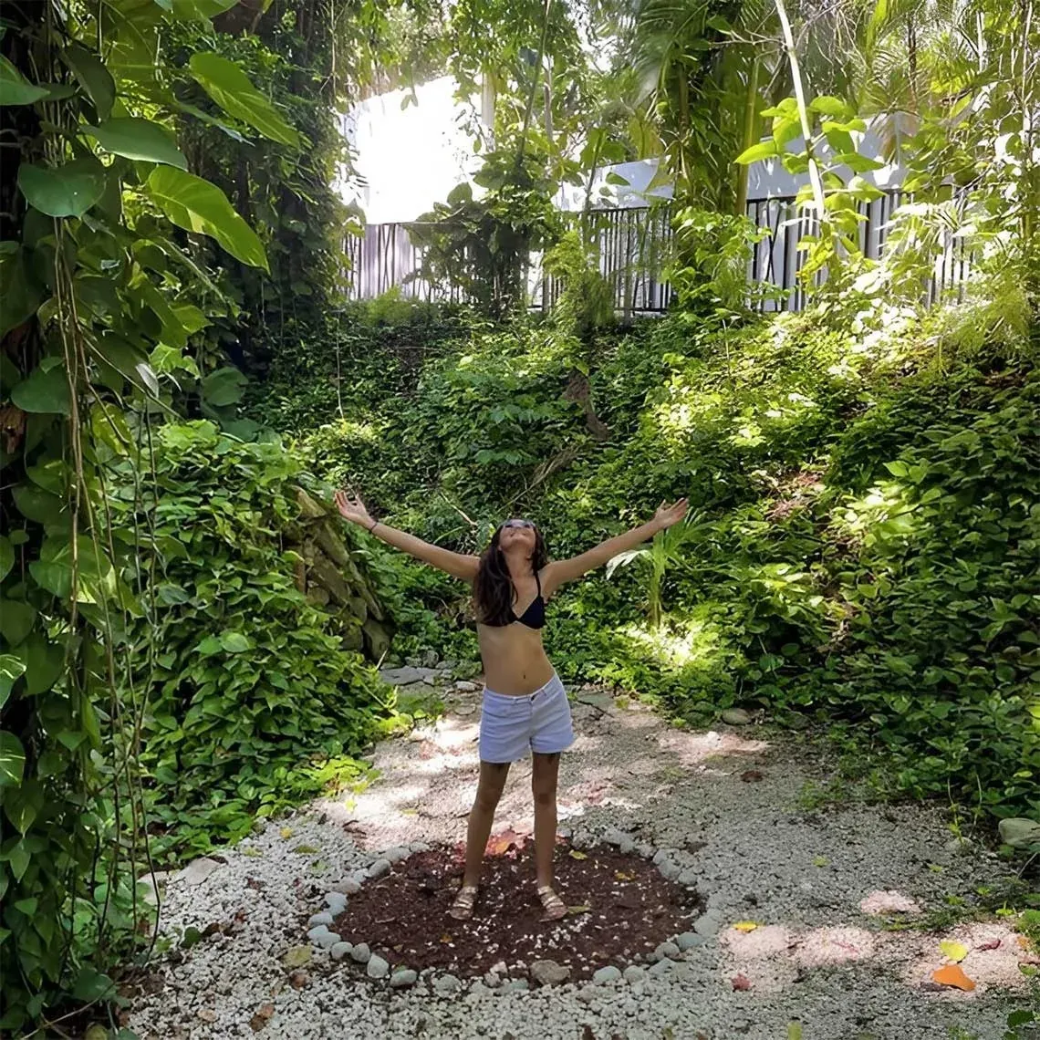 Young woman embracing nature at The Fives Corpo resort.
