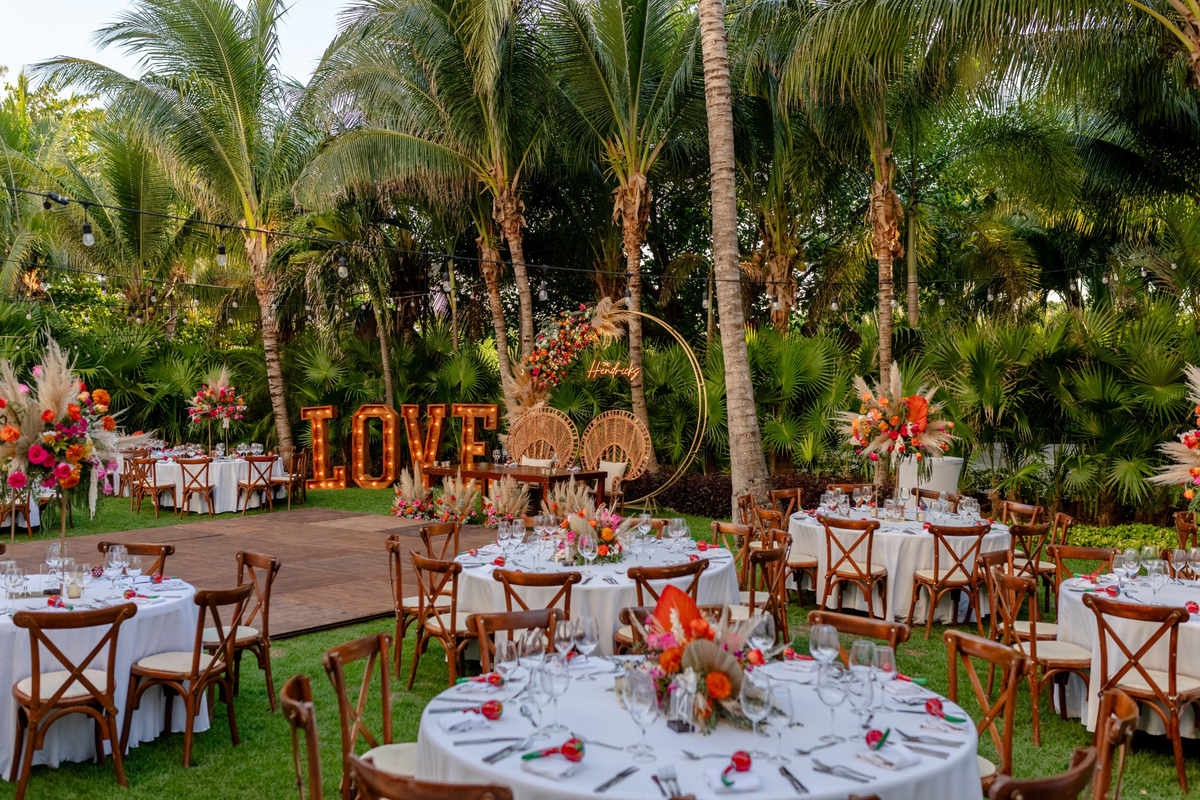 Outdoor garden wedding ceremony with tropical greenery in Riviera Maya