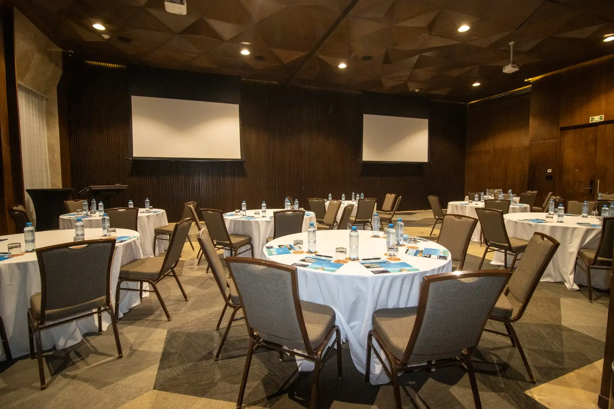 Meeting room setup with round tables and chairs, ready for The Fives Corpo events.