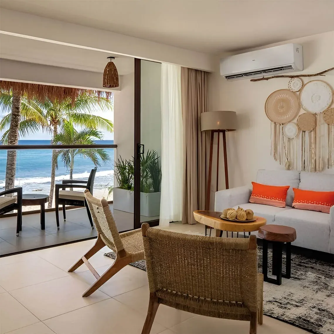 The Fives Corpo living room with ocean view and tropical balcony.