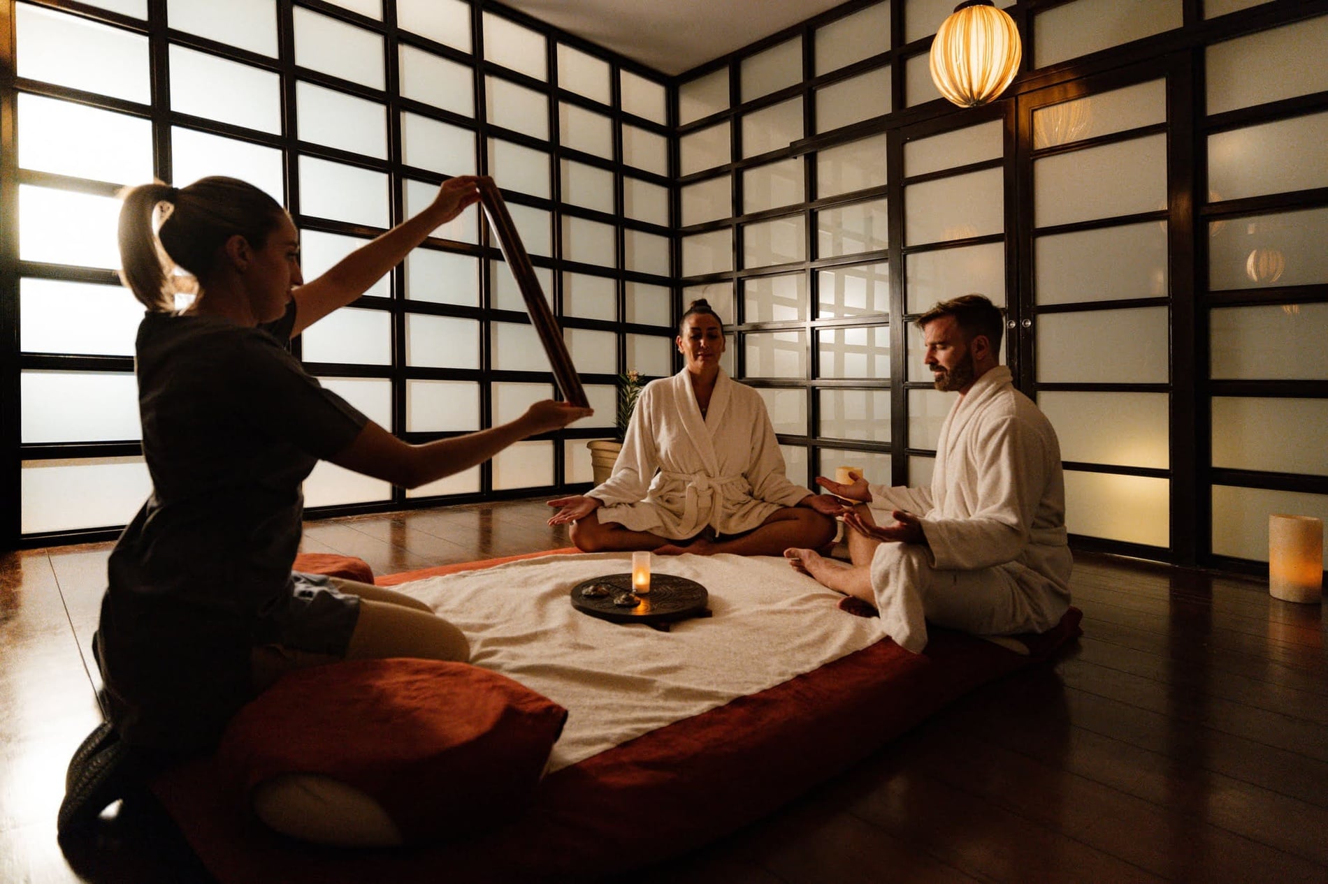 Rooftop hotel pool with waterfall and woman enjoying a relaxing spa experience.