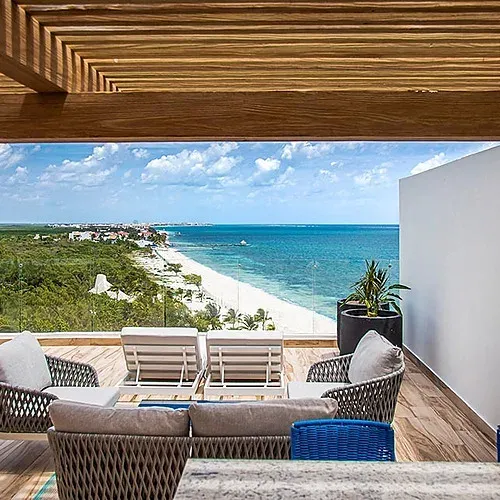 The Fives hotel terrace with Caribbean Sea view and white sand beach.